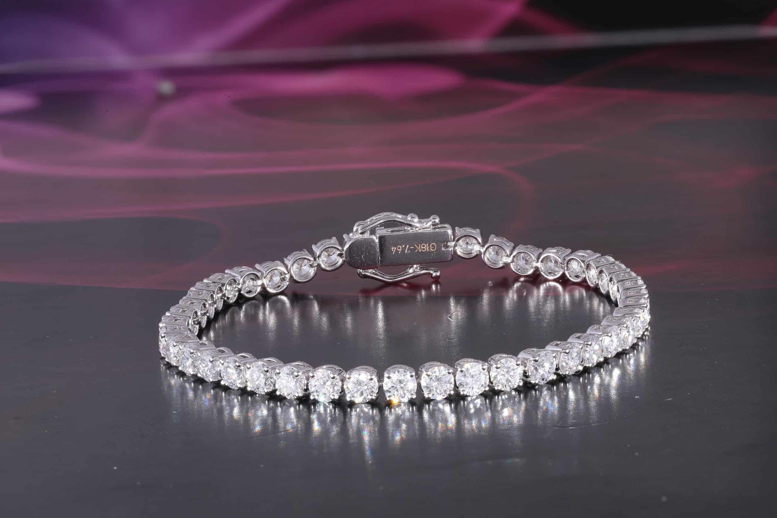 A diamond tennis bracelet with a diamond clasp