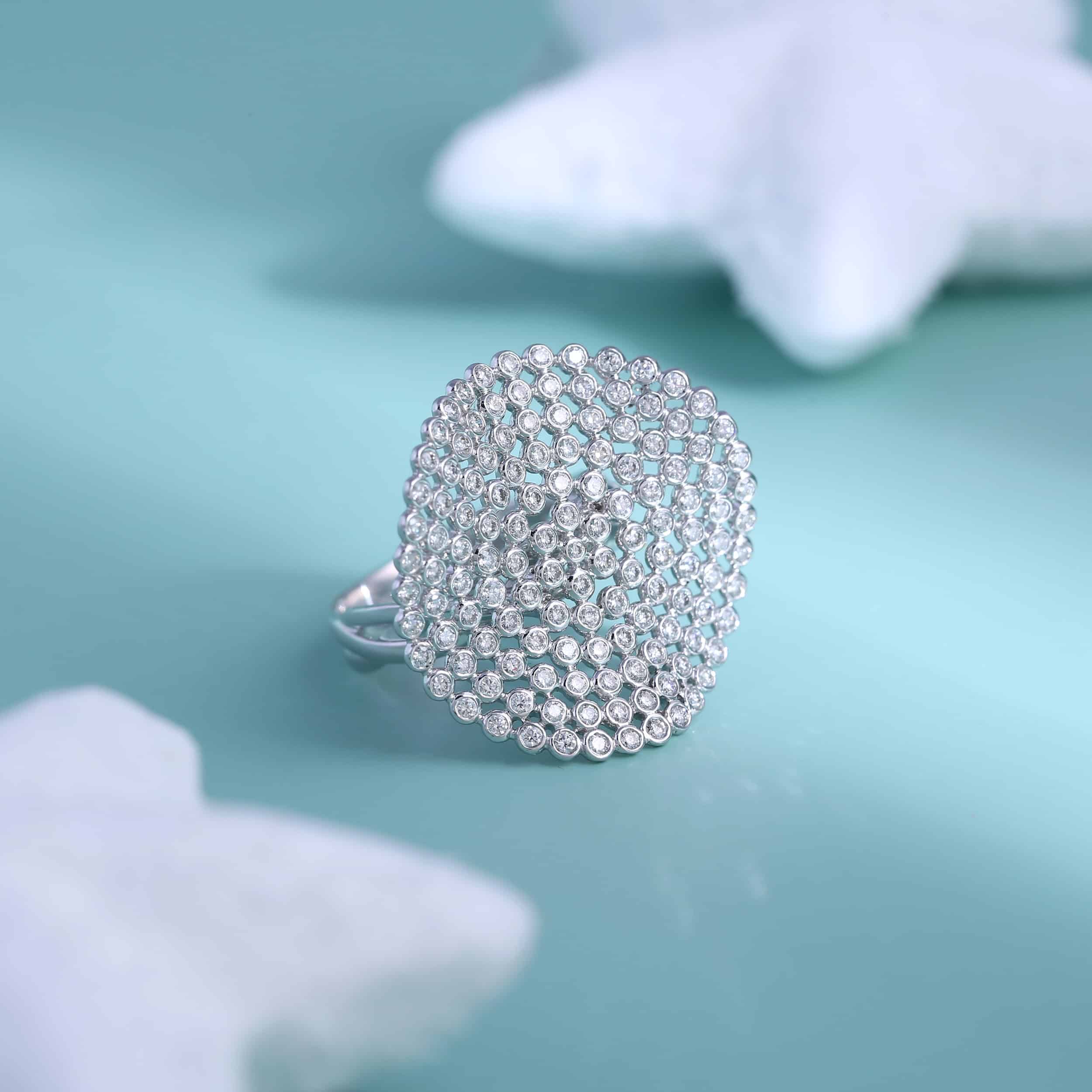 A silver ring with diamonds on a blue background