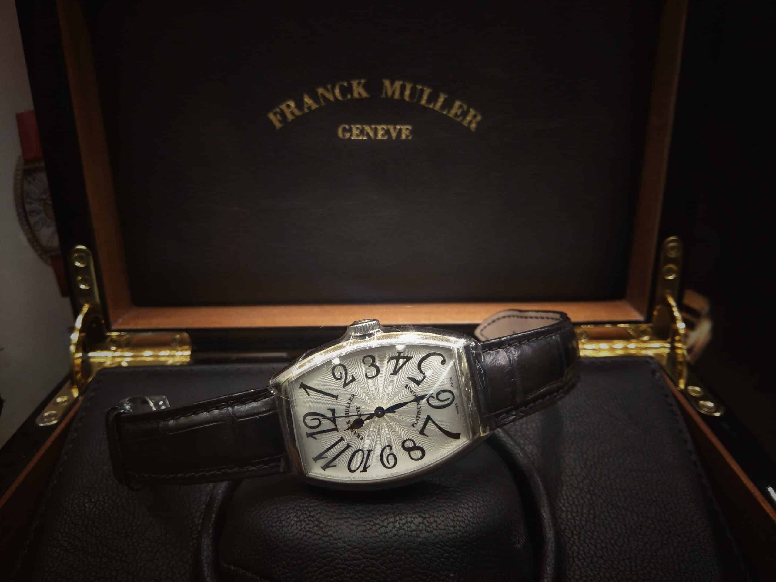 A watch in a black box with a white dial A watch in a black box with a white dial