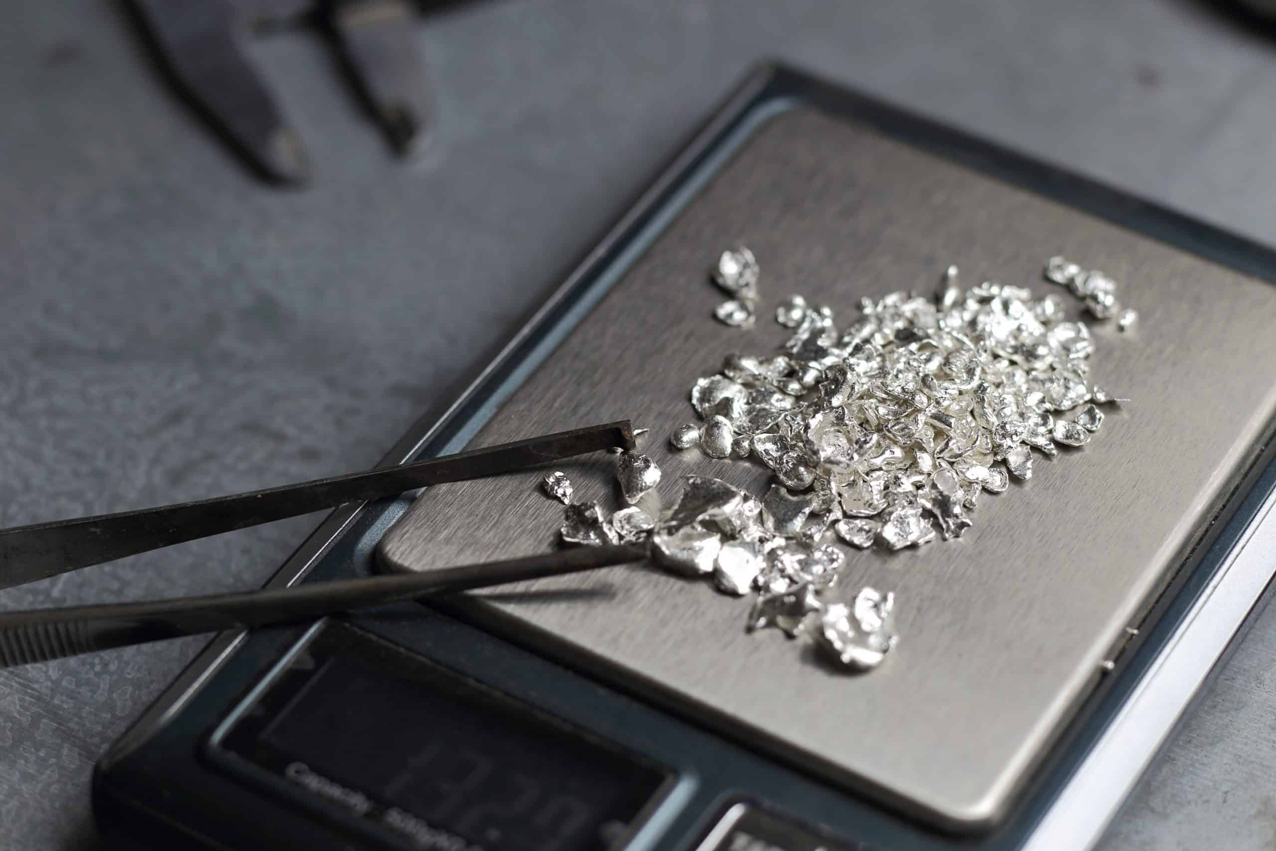 A scale with silver on it and a pair of scissors