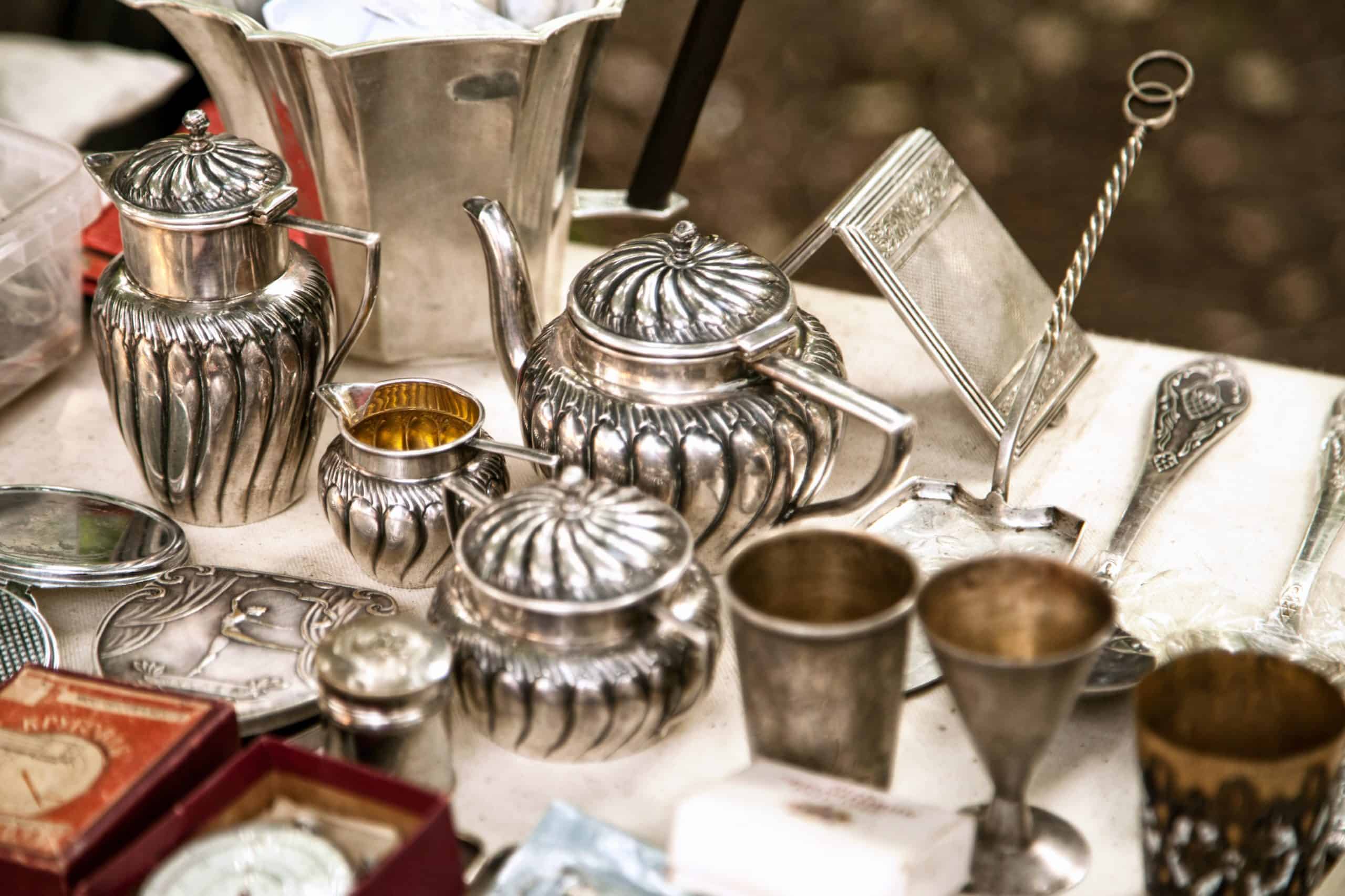 Antique silverware on a table at a flea market