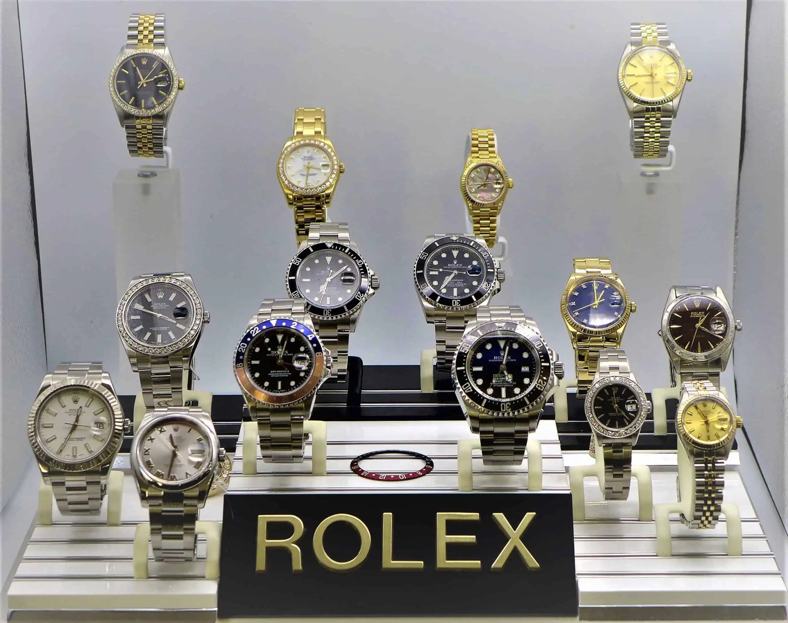 A display case with many different Rolex watches on display