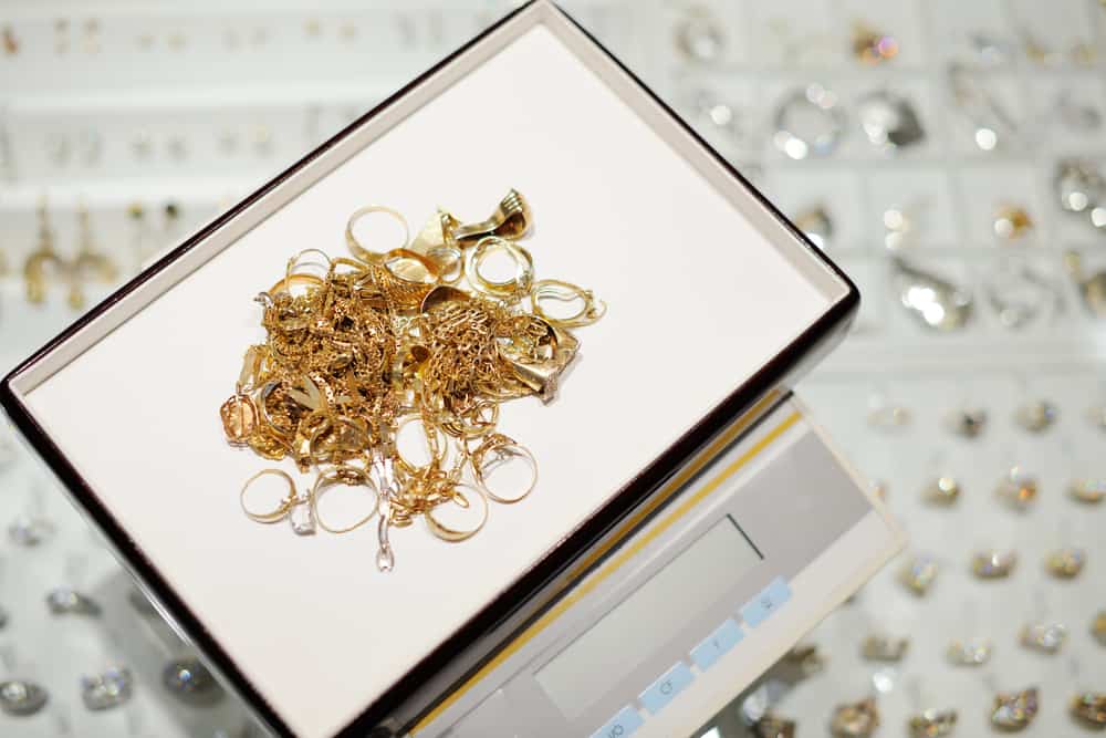 A box of gold rings sitting on a scale