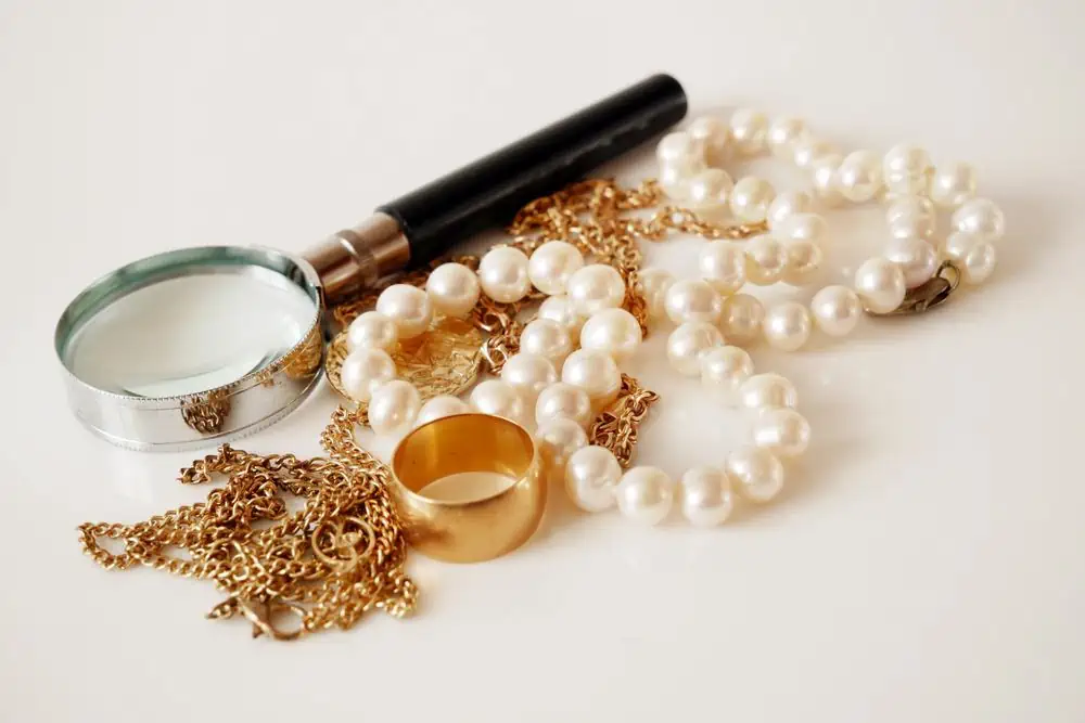 magnifying glass, pearls, necklace and ring