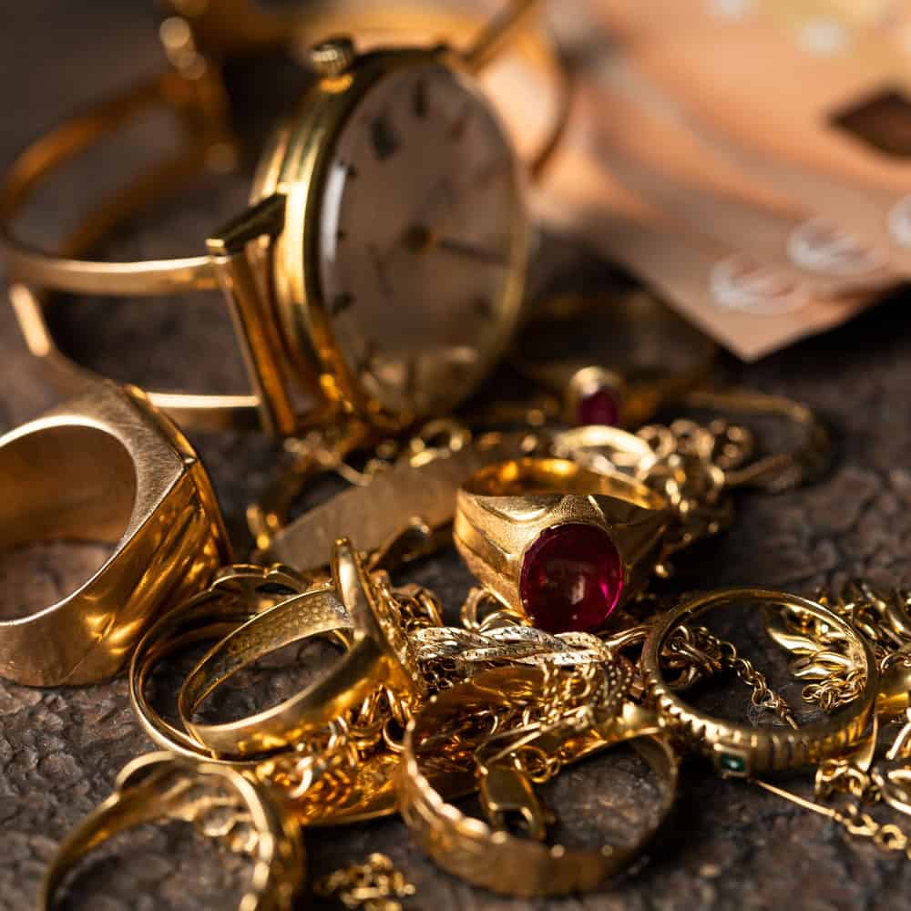 Gold jewelry and watches on a table